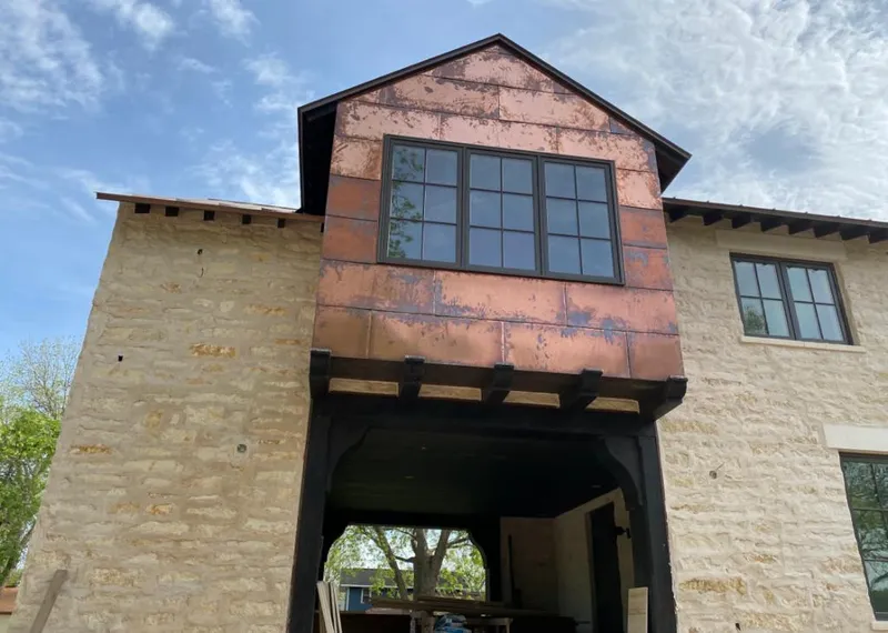 Copper metal panel facade on a stone building for Skylight Installation in La Habra